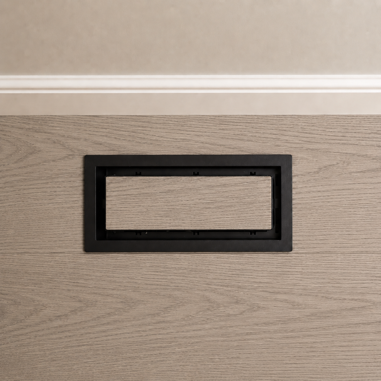 Top view of black 4x10 floor-matching vent cover in wood flooring